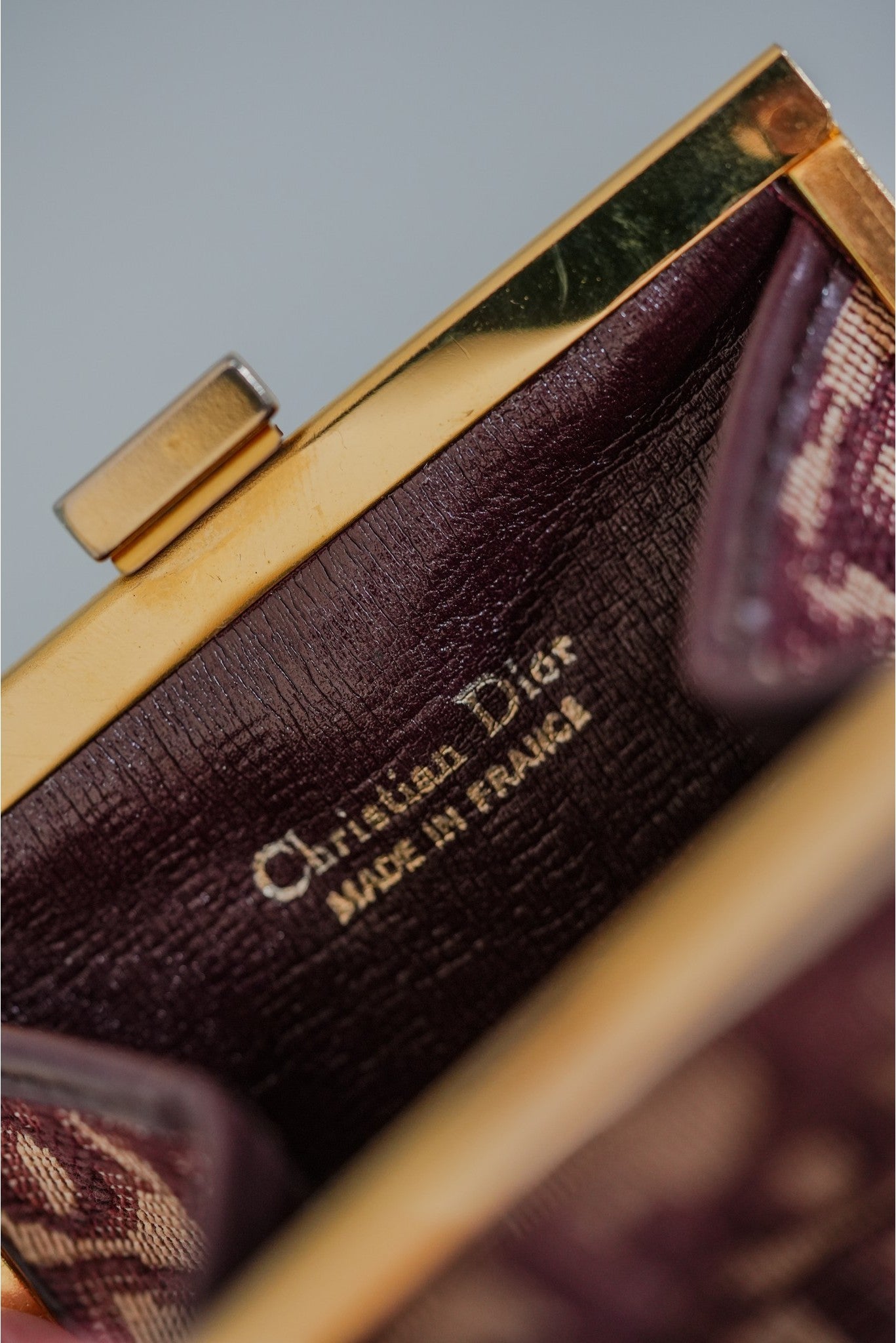 Christian Dior Trotter coin purse interior showing gold-tone frame and Christian Dior Made in France stamp