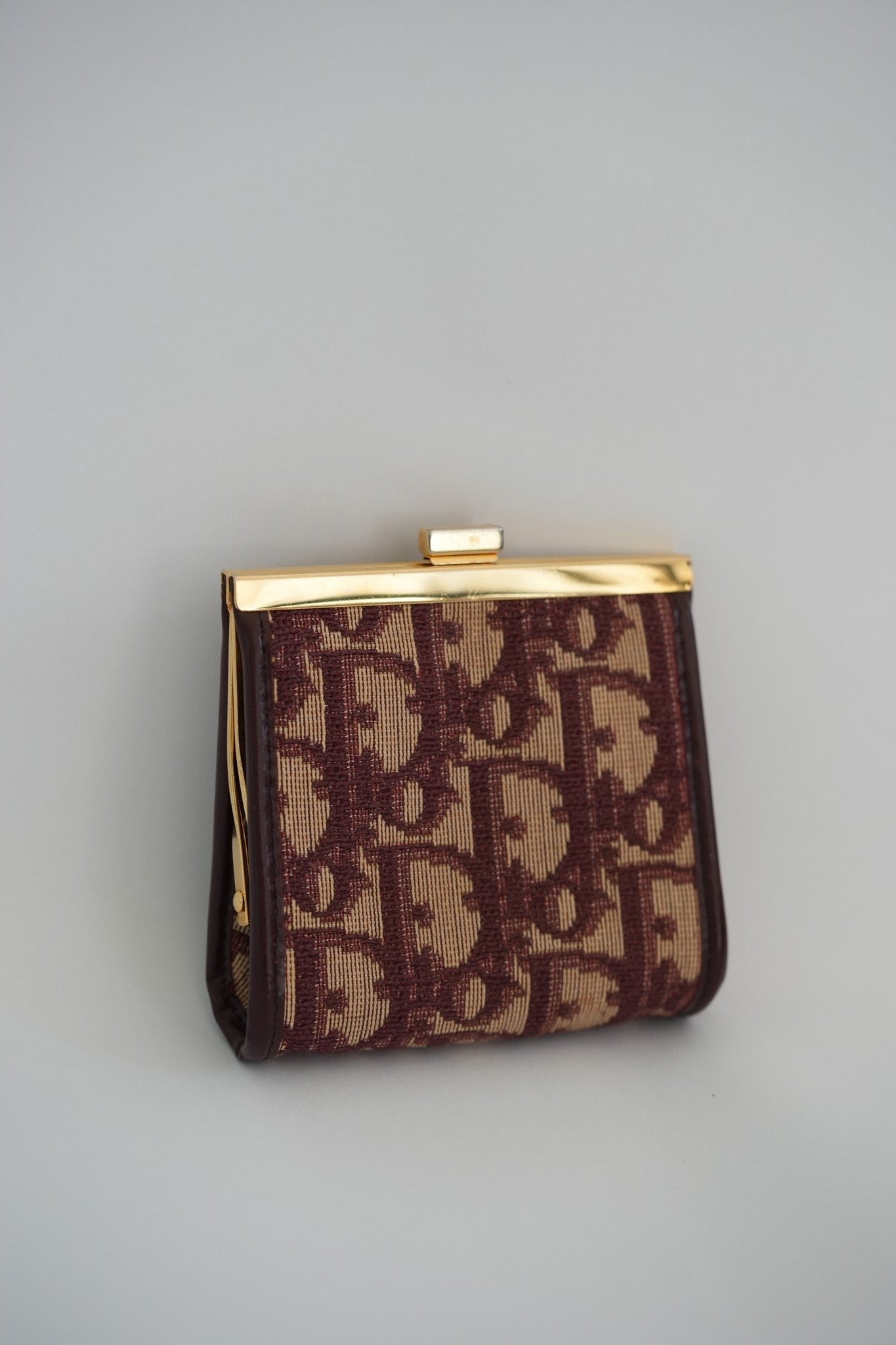 Vintage Christian Dior Trotter Oblique kisslock coin purse flat lay, front view