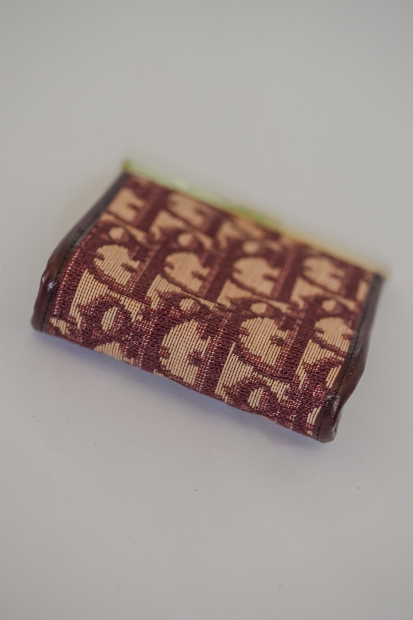 Vintage Christian Dior Trotter kisslock coin purse base detail, burgundy Oblique canvas close-up
