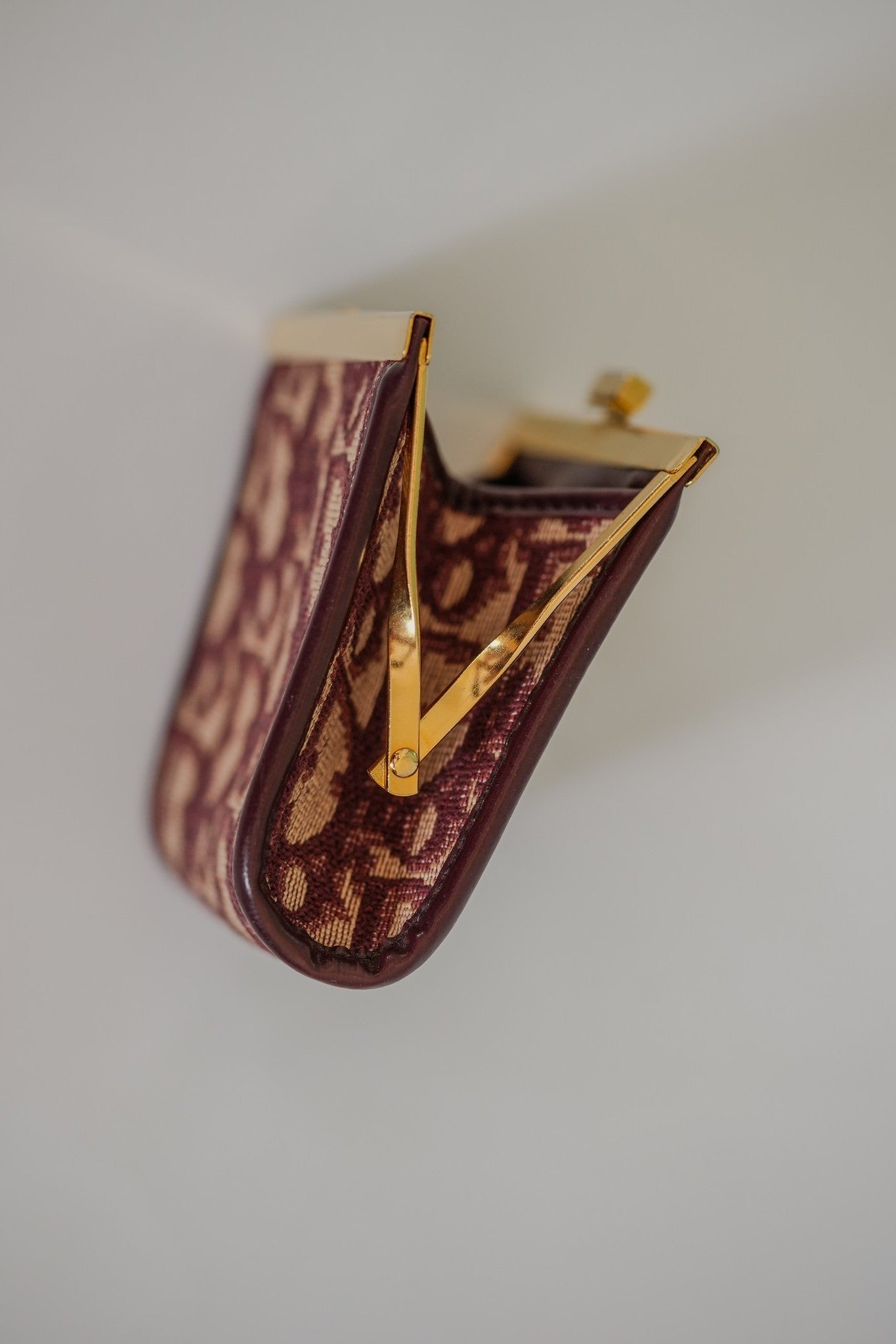 Vintage Dior Trotter kisslock coin purse open, showing interior gusset and gold-tone frame