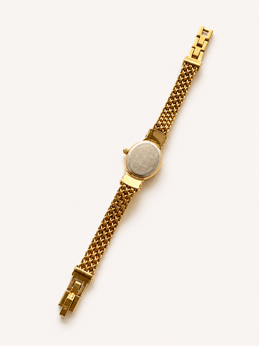 gold watch with chain detail against white background 