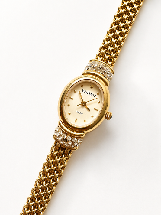gold watch with chain bracelet close up