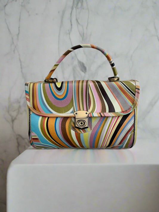 rainbow coloured bag on white table and marble background