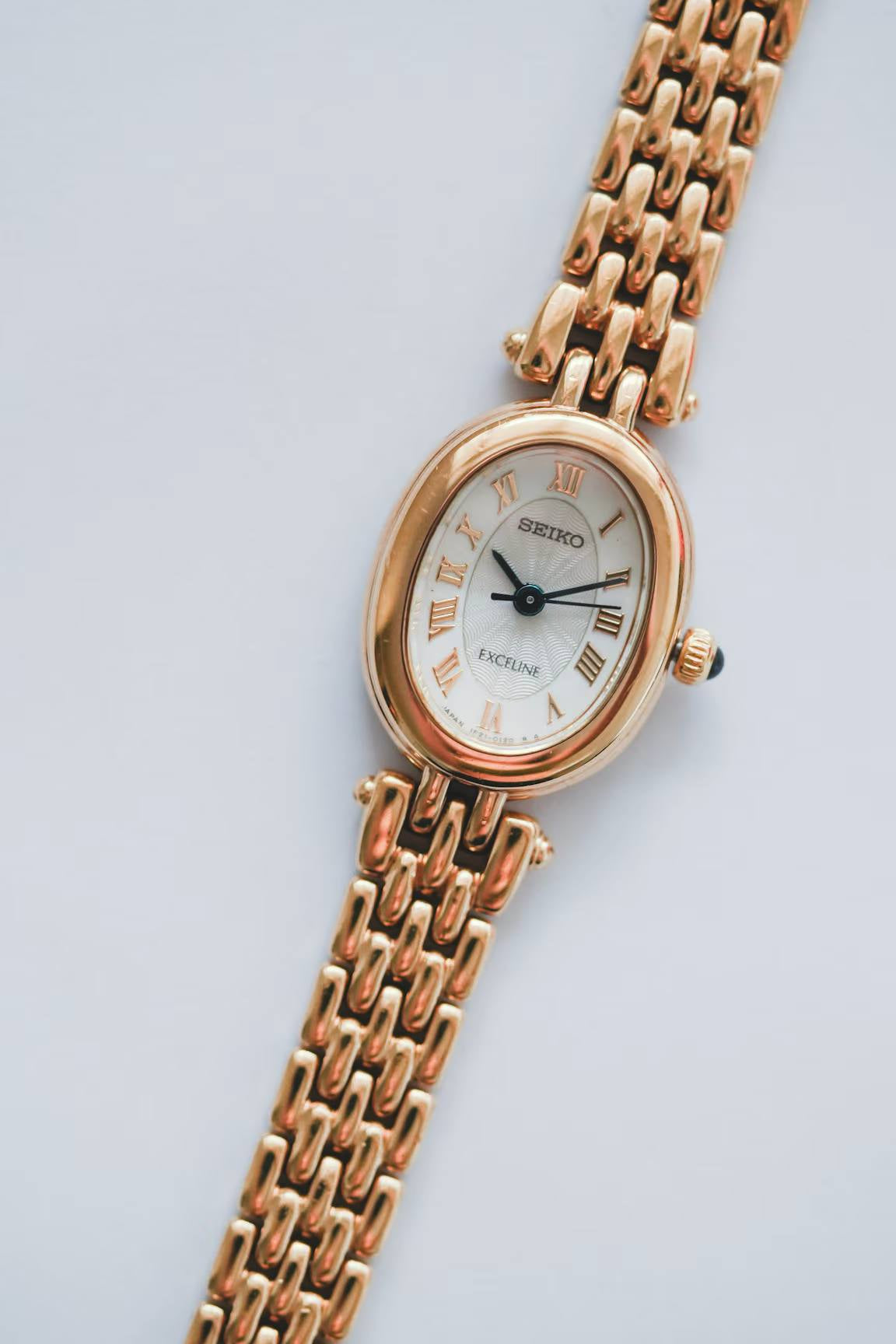 Seiko Exceline yellow gold watch flat lay with complimentary storage box near new old stock